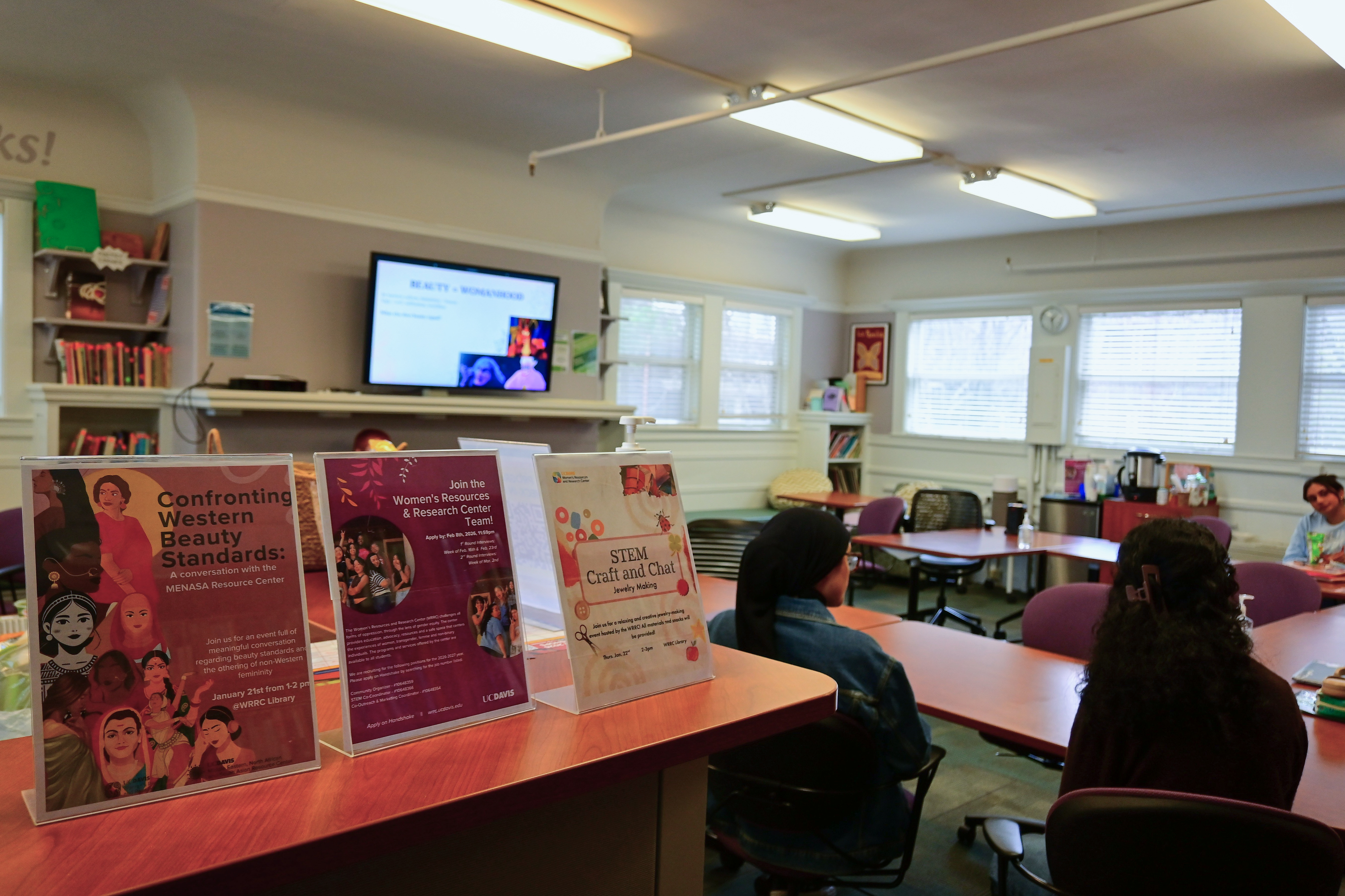 Signs for the Middle Eastern, North African and South Asian (MENASA) Resource Center's "Confronting Western Beauty Standards" event in the Women's Resources and Research Center on Jan. 21, 2026. (Julia Heron-Watts / Aggie)